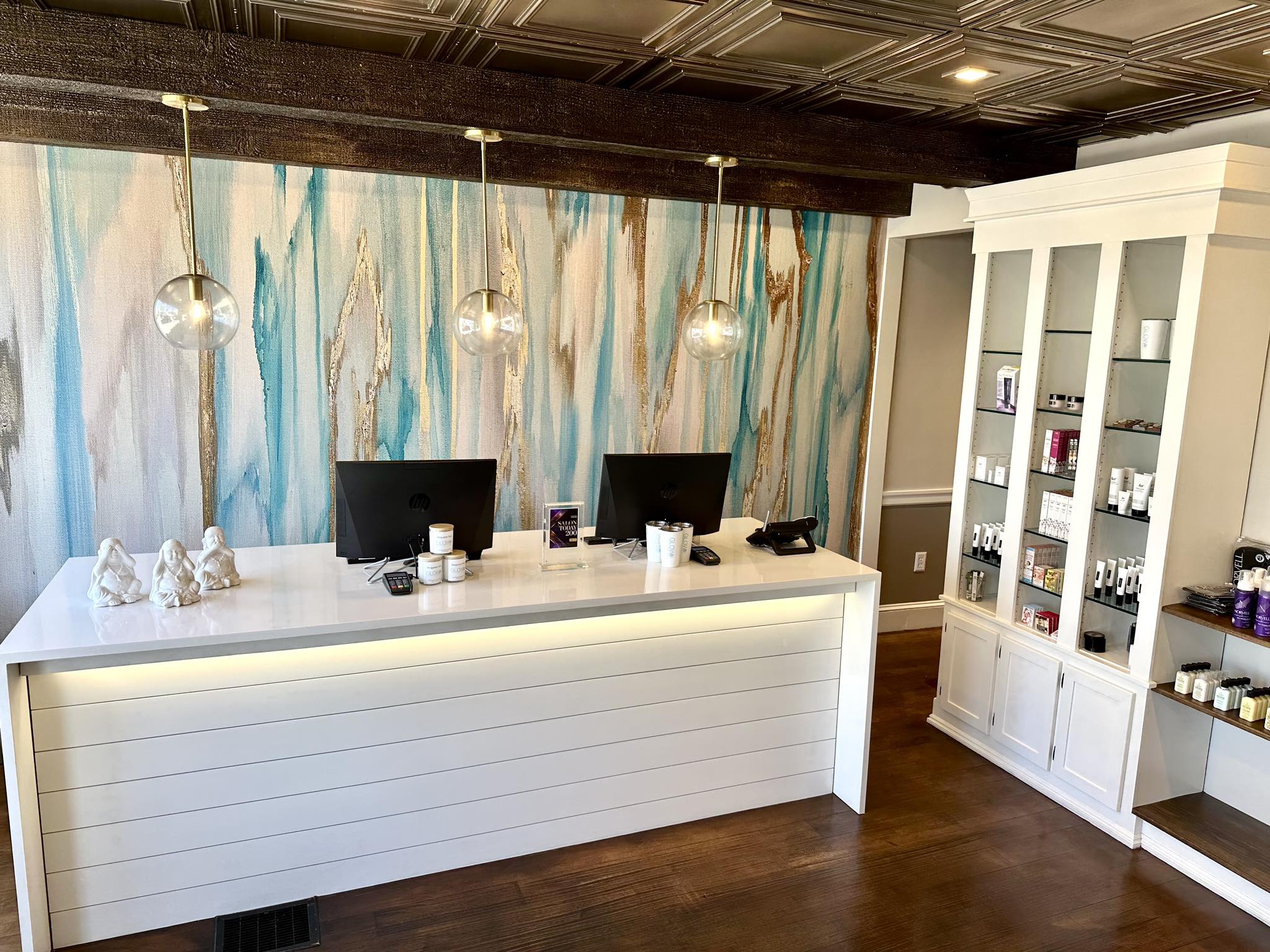 Glow Beauty Boutique skincare salon reception area with front desk, product displays, and esthetician treatment boutique interior